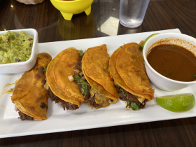 Birria tacos with consommé and guacamole