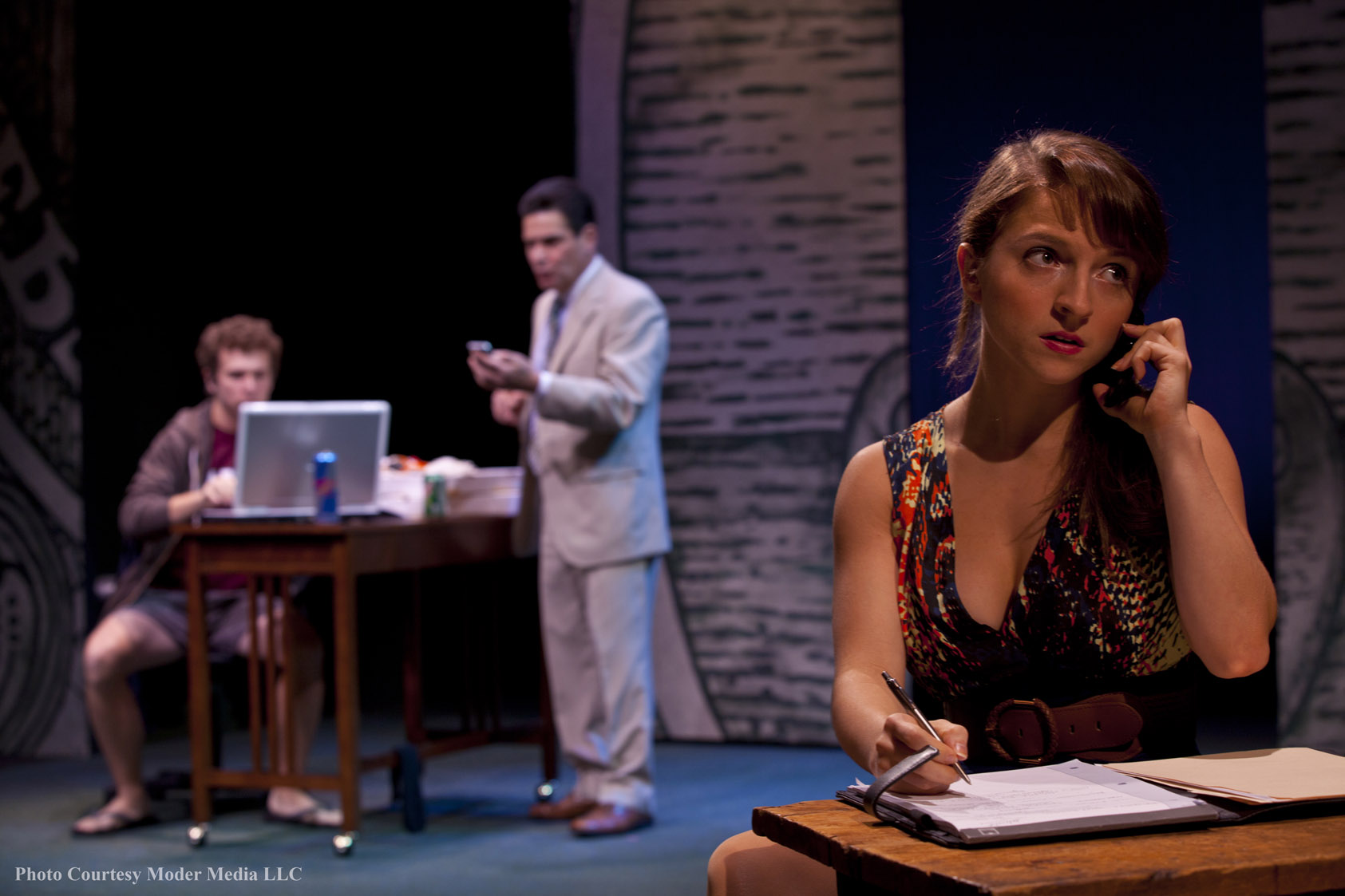 Ruthless banker Bennett (David Cecsarini, C) and his two allies Randy (Michael Cotey, L) and Lydia (Alexandra Bonesho) drive "Microcrisis," a satire of America's financial system. Photo courtesy of Moder Media LLC.