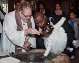 Pastor Twito baptizing a young girl.