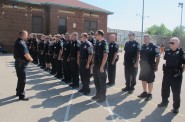 Officers from the 5th District stand at attention during the roll call. (Photo by Edgar Mendez)