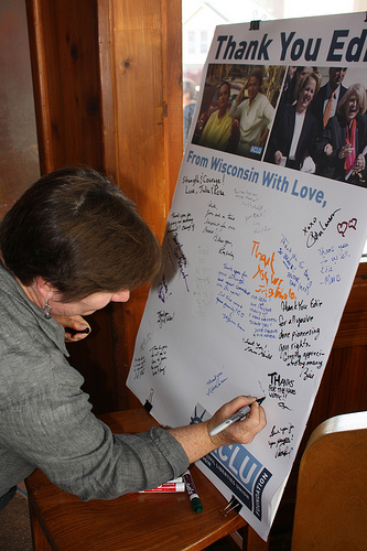 An attendee signs a card for Edie Windsor, the defendant in the DOMA case. (Photo by Maggie Quick)