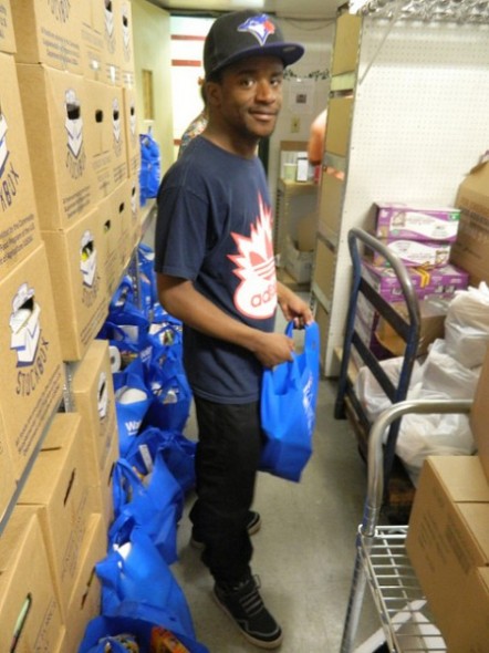 A volunteer packs bags of food for distribution (Photo by: Eric Oliver)