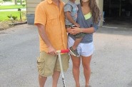 Rick Kohen and his daughter Kaitlyn have begun to teach JJ’s 3-year-old son Julius how to ride a scooter. (Photo by Edgar Mendez)