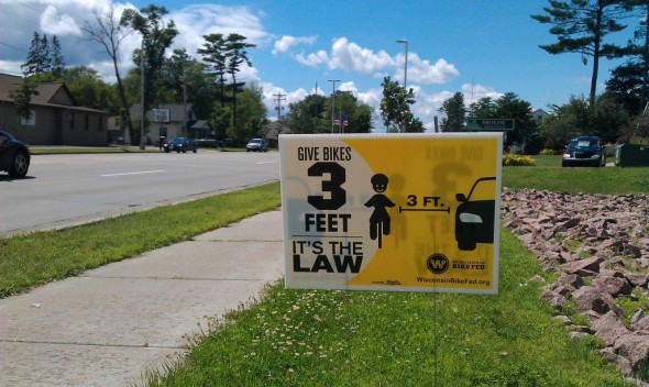 One of our Share and Be Aware yard signs encouraging people to obey the law that requires cars to pass bicycles by 3ft or more.