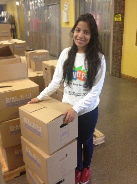 A student volunteers, helping sort food at the Hunger task Force. (Photo Courtesy of Milwaukee Public Schools)