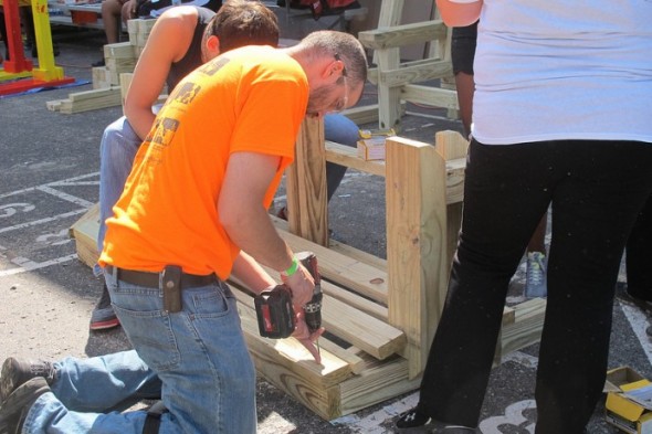 Volunteers build a wooden bench for a KaBOOM! playground at the Northside YMCA. (Photo by Shakara Robinson)