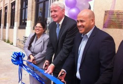 Executive director Patricia Ruiz-Cantu cuts the ribbon with Mayor Tom Barrett and Jose Perez during an event celebrating the opening of La Luz del Mundo Family Services violence prevention center. (Photo by Brendan O’Brien)