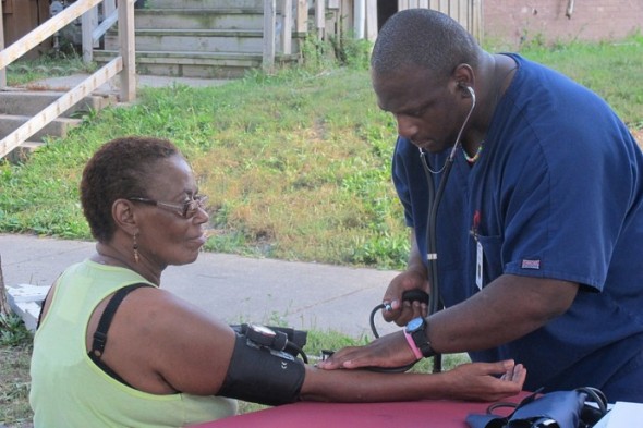 A resident receives a free blood pressure screening at a recent Metcalfe Park health and wellness event. (Photo by Shakara Robinson)