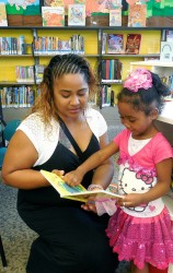Guadalupe Bedolla and her 4-year-old daughter, Rihanna, visit the Forest Home library every other weekend to check out children’s books. (Photo by Maria Corpus)