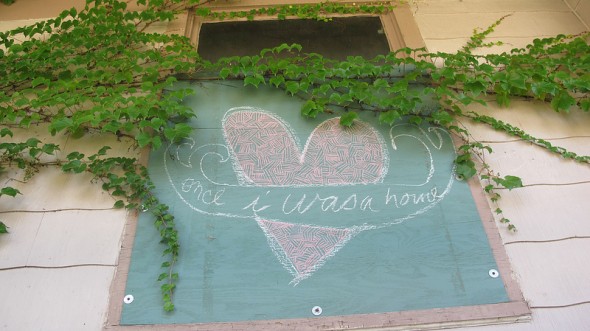 An artist leaves a message on a boarded-up window. (Photo by Scottie Lee Meyers)