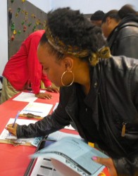 Tanesha Howard signs up to receive information from National Assistance Corporation of America, one of the many organizations at the resource fair. (Photo by Maria Corpus)
