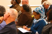 Sherman Park resident Sakeena Jawad (right) takes notes as panelists update the community on the Lindsay Heights Quality of Life Plan. (Photo by Rick Brown)