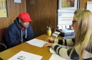 Supervisor Angela Catania explains how to regain a driver’s license to Hakim Fudge, who has 15 unpaid tickets, at the Center for Driver’s License Recovery and Employability. (Photo by Rick Brown)