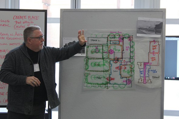 James Steiner of Quorum Architects explains design drawings for Site 4, the location of the former Garfield Avenue School. (Photo by Mark Doremus)