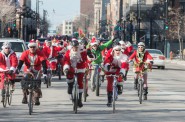 More than 100 West Side Santas head down Wisconsin Avenue to rendezvous with the other Santas at Lakefront Brewery.