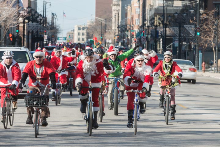 More than 100 West Side Santas head down Wisconsin Avenue to rendezvous with the other Santas at Lakefront Brewery.