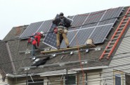 Contractors install solar panels to make the renovated house more energy efficient. (Photo courtesy of LBWN)