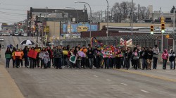 Community members march across the James E. Groppi Unity Bridge as part of a campaign to stop violence in Milwaukee. (Photo by Karen Slattery)