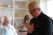Auxiliary Bishop for the Archdiocese of Milwaukee Donald J. Hying leads friends and supporters of the Clare Community project in prayer at a celebration of the new women's shelter. (Photo by Karen Slattery)