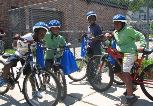 Neu-Life youth hop on their new bikes. (Photo by Brittany Carloni)