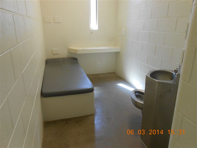 An unoccupied cell in the segregation unit at Waupun Correctional Institution. The cells are small, with a narrow window and concrete and steel furnishings. Photo from the Wisconsin Department of Corrections.