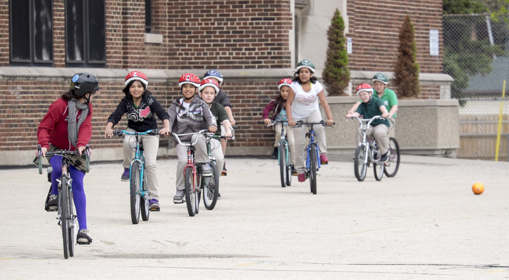 TAP grants help pay for Safe Routes to School programs at Milwaukee Public Schools. Here you see one of our Bike Fed bike/walk instructors teaching bicycle handling skills on the playground. We then take kids onto a street blocked off from traffic and finally on rides in traffic.