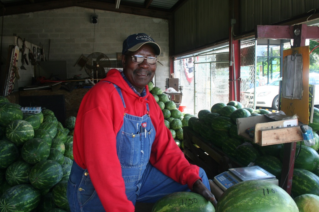 Douglas Moore poses with watermelons at the stand he tends on Sherman Boulevard and Capitol Drive.