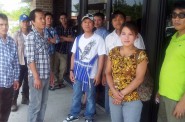 A group of Burmese workers waits outside the American Serb Hall, 5101 W. Oklahoma Ave., to get information about the Cargill beef slaughterhouse plant closing. (Photo by Edgar Mendez)