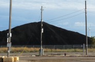 Coal pile, with the Bay View turbine in the background. Photo by Dave Reid.