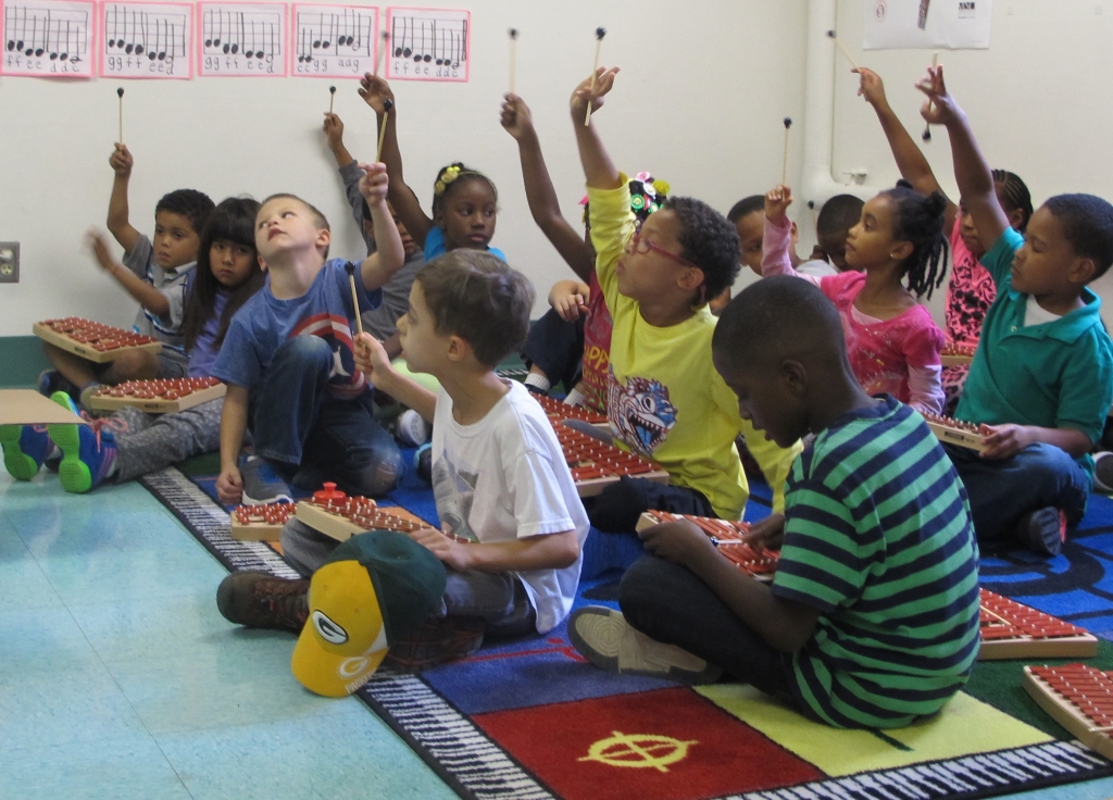 Woodlands’ students learn tone and rhythm while playing xylophones in music class, one of the specialty classes incorporated into the curriculum. (Photo by Molly Rippinger)
