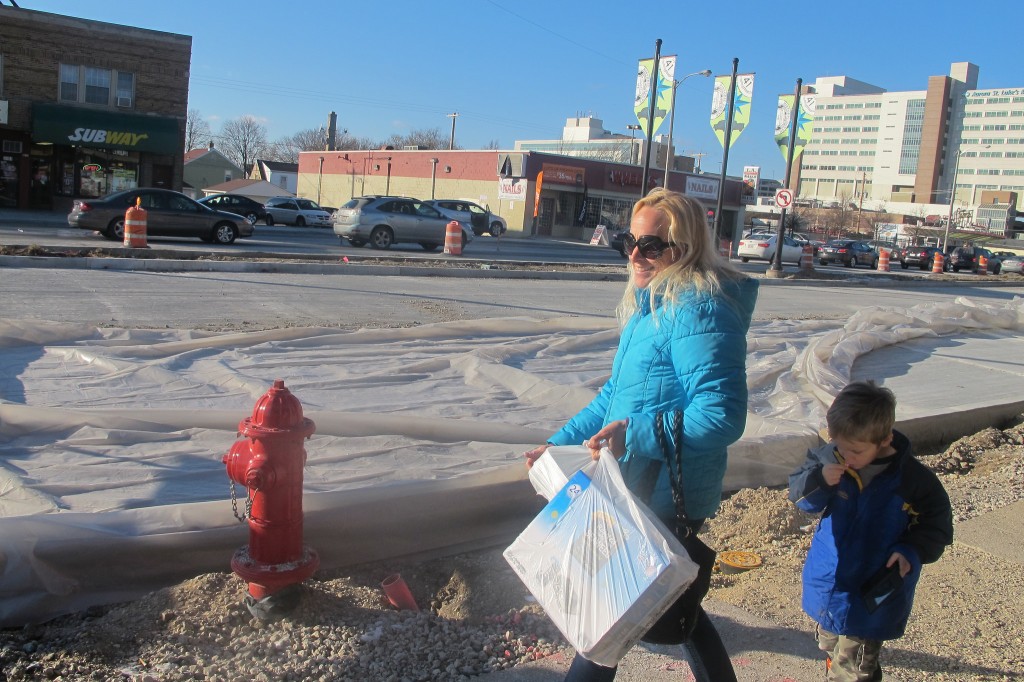 Ariane Fischer, walking along South 27th Street with her son Samuel, said the construction has caused her to take fewer trips to shops in the area. (Photo by Edgar Mendez)