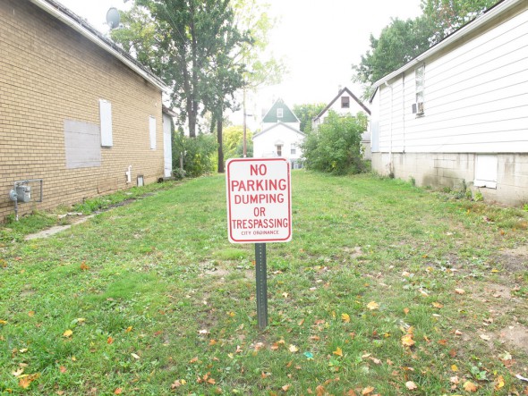 The sign on the lawn of 1119 W. Mineral St. makes it clear that the city has demolished this property and wants the public to steer clear.