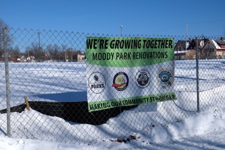 A sign hangs on a fence advertising the planned renovations at Moody Park. (Photo by Sue Vliet)