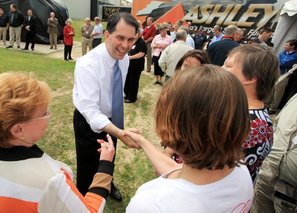 Gov. Scott Walker shakes hands of Ashley Furniture employees at a 2012 ceremony celebrating the company’s Whitehall expansion. The company is eligible to receive $6.7 million in state tax credits, nearly four times the amount of federal fines it faces for allegedly violating worker safety laws. Photo by Andrew Link/Winona Daily News.