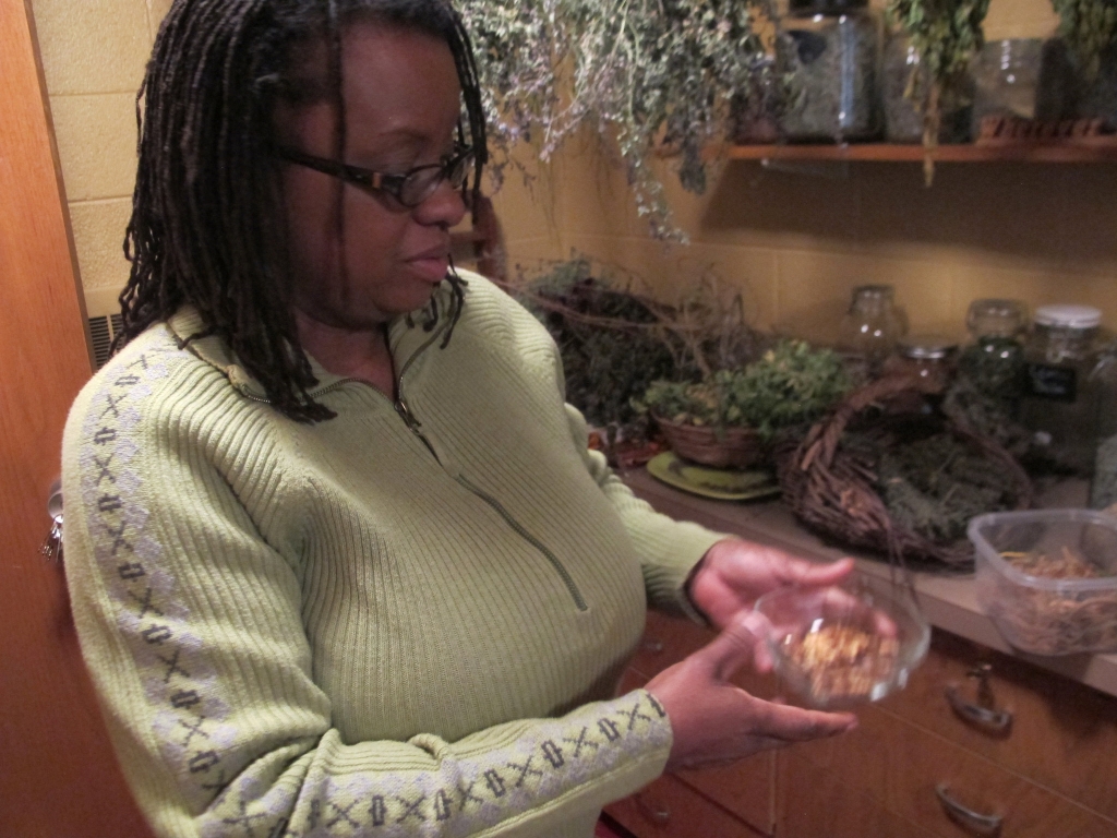 Venice R. Williams checks on her herbs in her herbal drying room and seed garden at the Body & Soul Healing Arts Center, 3617 N. 48th St. (Photo by Teran Powell)