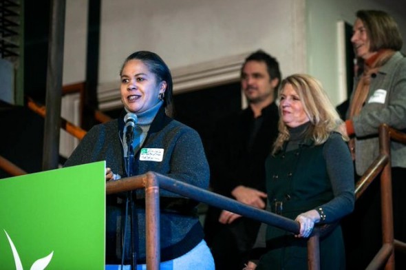 Angela Moragne, co-owner of That Salsa Lady, speaks at the Kiva City Milwaukee launch party. Listening are Wendy Baumann (center), president and CVO of WWBIC, John McWilliam, owner of Scátháin, and Martha Brown (right), deputy commissioner of Milwaukee Department of City Development. (Photo courtesy of Mark Hines Photography)