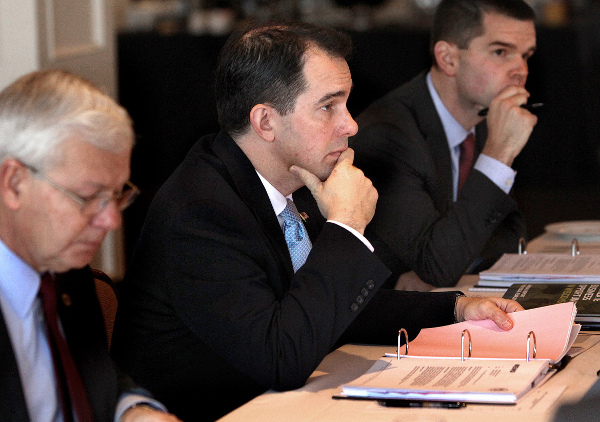 Gov. Scott Walker, then-chairman of the Wisconsin Economic Development Corp., participates in a WEDC board meeting in late 2013 in La Crosse along with CEO Reed Hall, left, and then-chief operating officer Ryan Murray. Walker, a candidate for president, recently removed himself from the board after a negative audit and critical news coverage of the job-creation agency. Photo by Peter Thomson of the La Crosse Tribune.