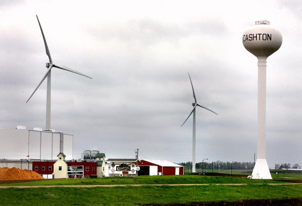 These wind turbines, a joint venture between Organic Valley and Gundersen Lutheran Health System, loom over Organic Valley’s distribution center in Cashton, Wis. Photo by Peter Thomson of the La Crosse Tribune courtesy of the Wisconsin Center for Investigative Journalism.