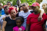 Arifah Akbar, Nazir Akbar and Katraile Scott stand together during a vigil for Tariq Akbar, on July 7. Tariq was shot to death July 3 in Milwaukee, after watching a fireworks display with his friends. Photo by Katie Klann of the Milwaukee Journal Sentinel.