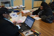A volunteer tax preparer works with a client at SDC’s Teutonia site. Photo provided by SDC.