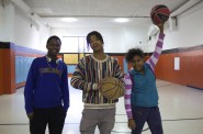 Rodney McCoy, Cameron Henderson and Zuriah Haynes pose during their basketball game. Photo by Emmy A. Yates.