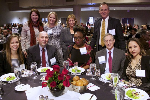 Tom Schneider, executive director of COA Youth & Family Centers (second from right, seated) gathers with colleagues at the MANDI event. Schneider accepted the BMO Harris Bank Cornerstone Award on behalf of his organization. Photo courtesy of NNS.