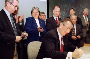 Gov. Tommy Thompson signs the 1999-2001 state budget. University of Wisconsin Chancellor David Ward and University of Wisconsin System President Katharine Lyall watch. Photo by Jeff Miller of UW-Madison.