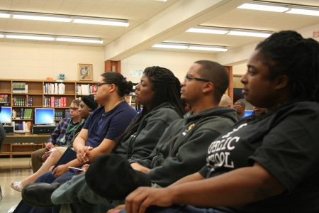 (From right) Ingrid Walker-Henry, Jamaal Smith, Martha De La Rosa and others listen to speakers during a community schools event at James Madison Academic Campus. Photo by Jabril Faraj.