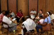 Attendees share stories in discussion circles during a recent listening session on police-community relations. Photo by Jabril Faraj.