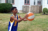 J’Ali Thornton practices with a basketball in front of his house. Photo by Andrea Waxman.
