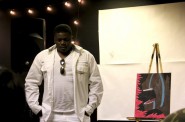 Stephan Bell, 17, a James Madison High School senior, presents his painting and poem at TRUE Skool’s summer showcase. Photo by Rebecca Carballo.
