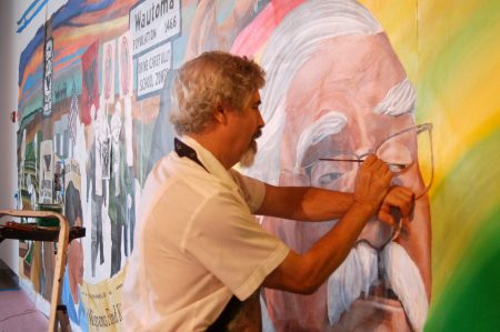 Raoul Deal, lead artist and senior lecturer at UW-Milwaukee’s Department of Art and Design at the Peck School of the Arts, touches up an image of Jesus Salas. Photo by Edgar Mendez.
