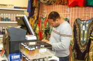 Edgar Birdsong records business information at his shop on North King Drive. Photo by Clara Hatcher.