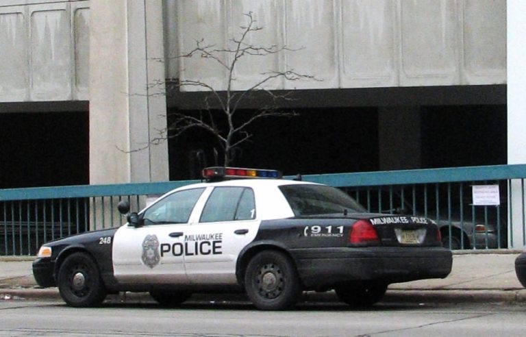 Squad cars are parked outside of the City of Milwaukee Police Administration building. Photo by Brendan O’Brien.
